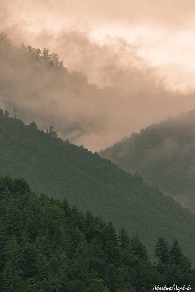 Monsoon mist rolling over the forested hills of Nepal